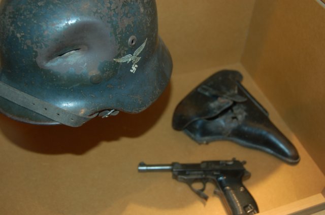 perforatedluftwaffehelmetwithp38pistol.jpg