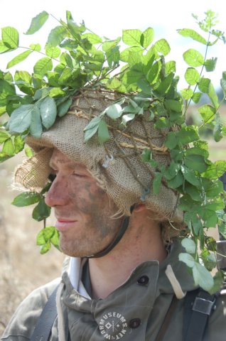 germansoldierwithcamouflagedhelmet.jpg